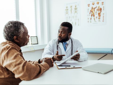 African American man talking with a doctor. 