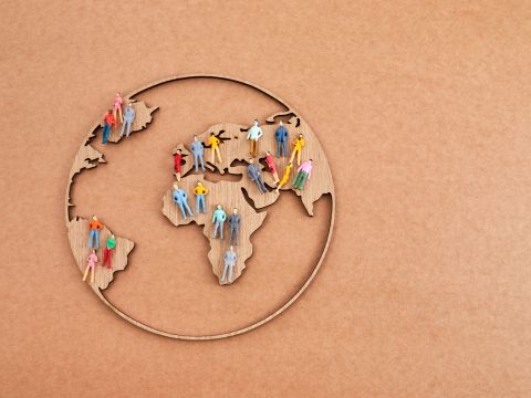 Outline of a world globe with people. 
