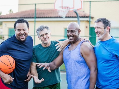 Group of men playing basketball together. 