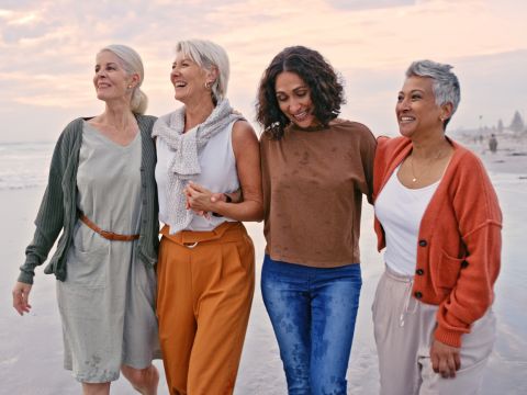 Group of diverse women walking on the beach. 
