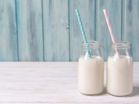 Milk in glass bottles with straws. 
