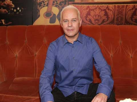 James Michael Tyler sitting on "Friends" couch.