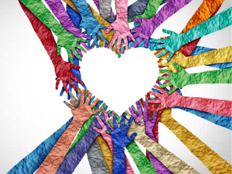 Collage of multi-colored hands together making a heart shape. 
